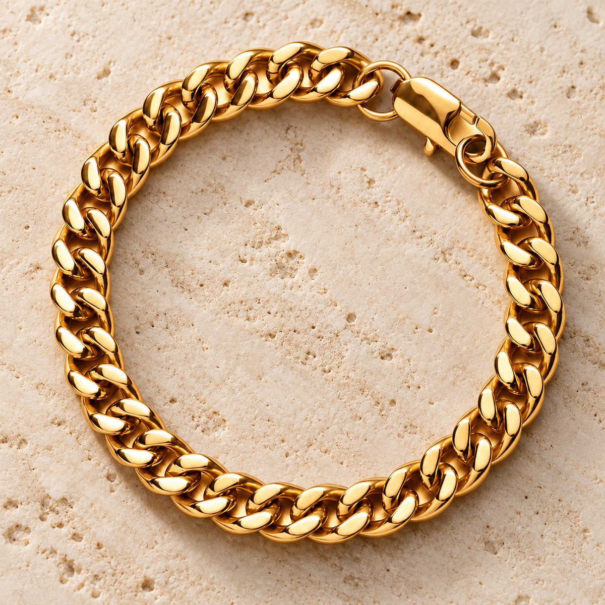 The Lil Cuban — Gold-tone detail view on cream stone