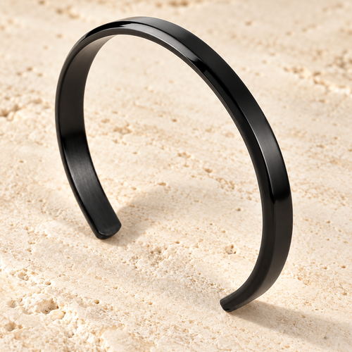 The Arc Cuff — Black detail view on cream stone