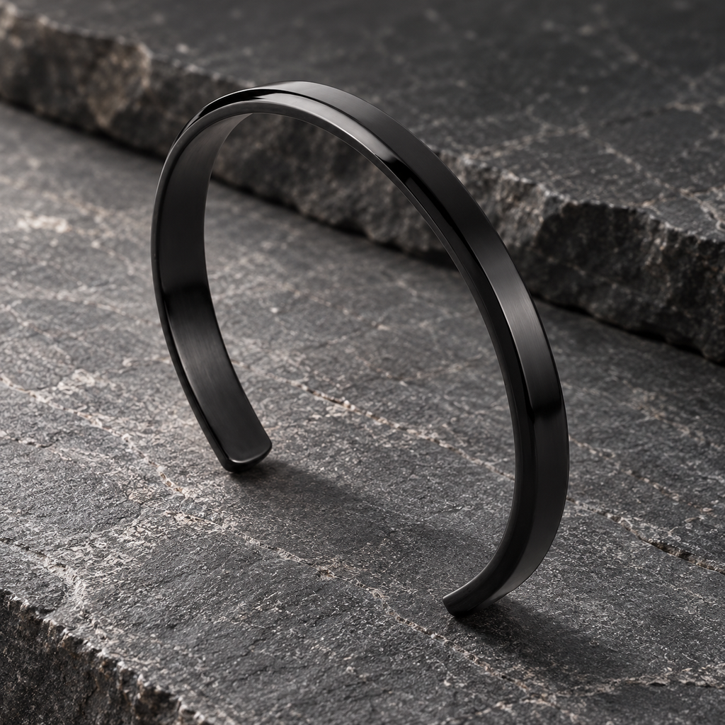 The Arc Cuff — Black editorial view on charcoal stone