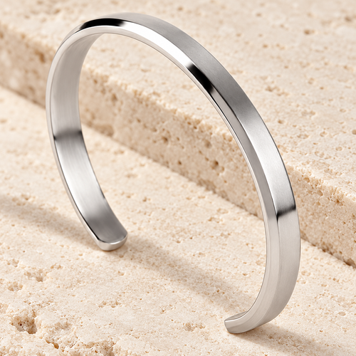 The Arc Cuff — Silver-tone detail view on cream stone