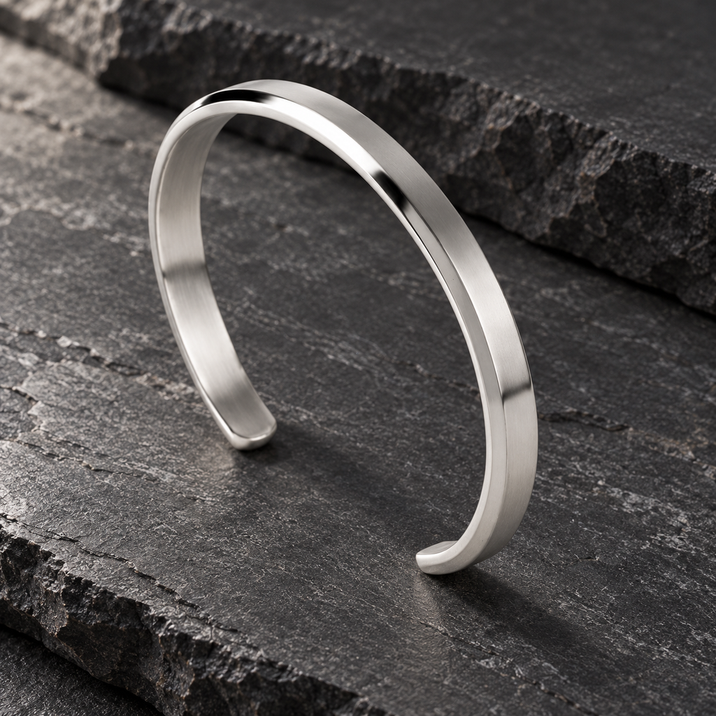 The Arc Cuff — Silver-tone editorial view on charcoal stone