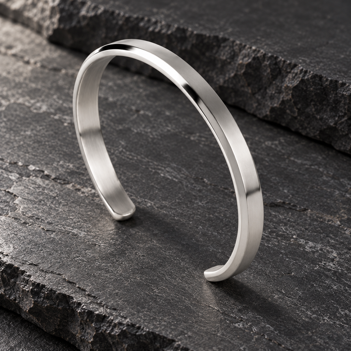 The Arc Cuff — Silver-tone editorial view on charcoal stone