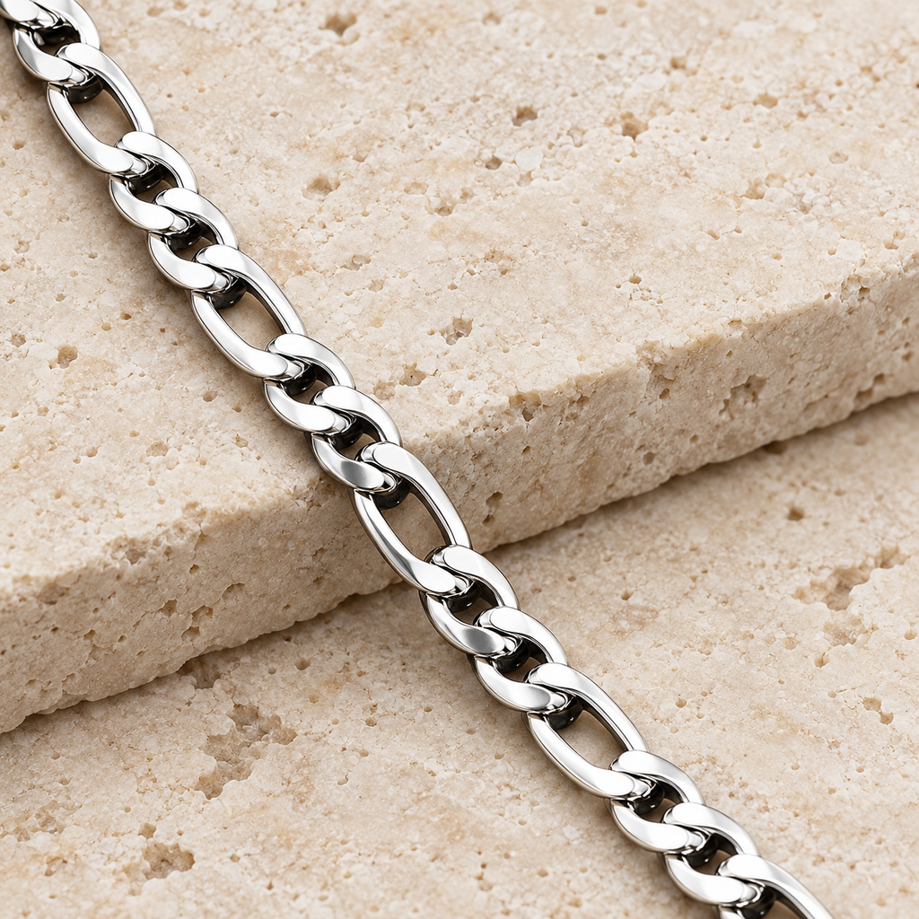 The Figaro Chain — Silver-tone editorial view on charcoal stone