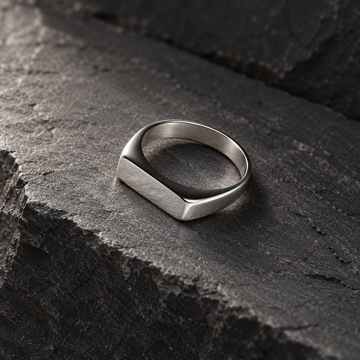 The Frame Signet — Silver-tone editorial view on charcoal stone