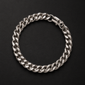 NORTHLINE Lil Cuban silver-tone Cuban-link bracelet with clasp on a dark surface